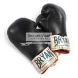 A pair of vintage boxing gloves signed by Henry Cooper,