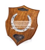 A racing plate worn by Shergar when winning the 1981 Epsom Derby, mounted on a mahogany shield,