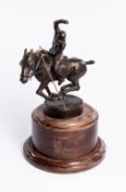 A bronze of a polo player & pony, the base incised TOMMY N 02, modelled in match action,