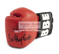 A BBE boxing glove signed by the legends Frank Bruno, Sir Henry Cooper and Chris Eubank,