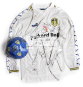 A Leeds United FC home replica jersey and a football, both autographed by the players, circa 2000,