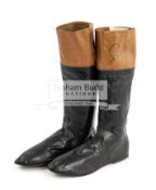 A pair of signed Champion jockey Michael Roberts leather boots, the black and brown leather boots,