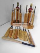 A pair of cricket table lamps and a selection of facsimile signed miniature cricket bats each table