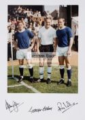 A colour photograph featuring and signed by three England 1966 World Cup winners Alan Ball,