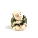 A Japanese finely carved and inlaid ivory netsuke, Meiji period (1868 - 1912).