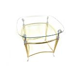 A modern Hollywood Regency brass and glass topped table.