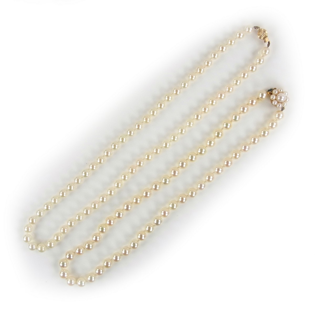 Two 9 ct yellow gold pearl necklaces.