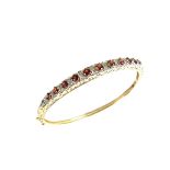 9 ct yellow gold garnet and diamond bangle.