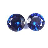 Pair of loose circular cut synthetic sapphires.