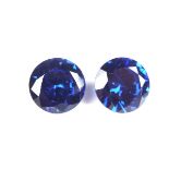 Pair of loose circular cut synthetic sapphires.