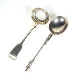 A Victorian silver tea strainer and Apostle spoon.