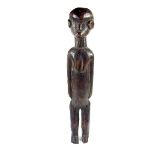 Tribal Art: An East African carved wood Nyamwesi standing figure, Tanzania, late 19th century.