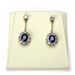 Yellow gold sapphire and diamond cluster drop earrings.