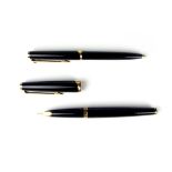 A Mont Blanc matching fountain pen and ballpoint pen set in black and gold, circa 1950s.