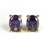 Yellow gold purple stone ear clips.