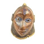 Tribal Art: An African carved wood helmet mask, Yoruba People, Nigeria, early 20th century.