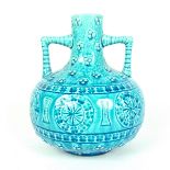 A Burmantoft twin handled faience pottery vase.