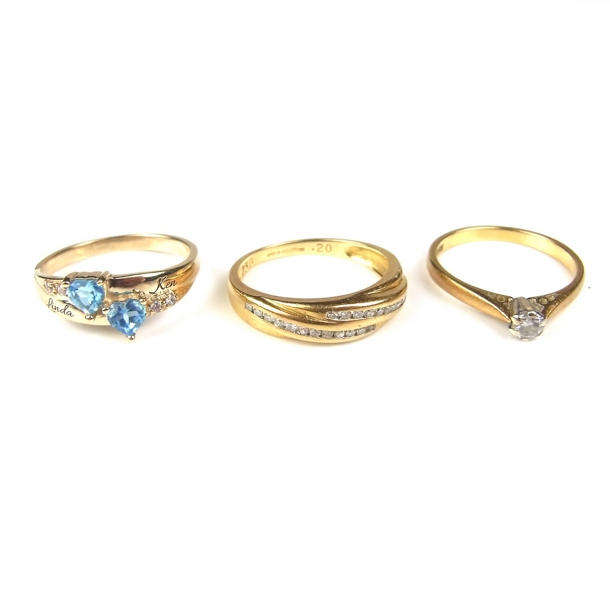 Three yellow gold gem set rings.