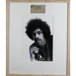 A large Jimi Hendrix b/w photograph framed with a signed backstage pass.