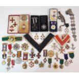 AN ORDER OF ST JOHN BREAST BADGE in black and white enamel with other Order of St. John medals and