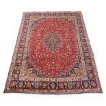 A PERSIAN MESHED RED GROUND RUG with a traditional Aronian medallion design, 380cm x 294cm Condition