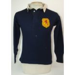 A BLUE SCOTLAND INTERNATIONAL SHIRT with embroidered cloth badge, areas of moth holes and a blue