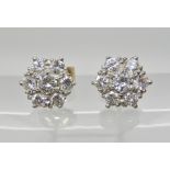 A PAIR OF DIAMOND FLOWER STUDS set with estimated approx 0.82cts of brilliant cut diamonds, head