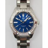 A STEEL AND DIAMOND SET TAGHEUER AQUARACER WRISTWATCH with blue metallic dial, date aperture and