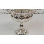 A HAMMERED SILVER TWIN HANDLED PEDESTAL BOWL by George Nathan and Ridley Hayes, Chester 1910, with