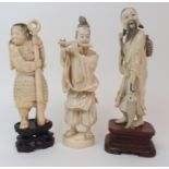 AN IVORY OKIMONO OF A DISHEVELLED FISHERMAN on a wood stand, 22cm high, an Okimono of a flautist,