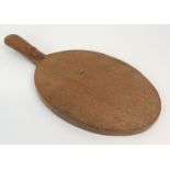A ROBERT 'MOUSEMAN' THOMPSON OF KILBURN OAK CHEESE BOARD of oval form, the handle carved with a