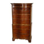 A MAHOGANY SERPENTINE CHEST ON CHEST with four graduating drawers above three drawers on bracket