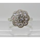AN 18CT WHITE GOLD DIAMOND FLOWER RING the central diamond is estimated approx 0.30cts and