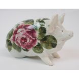 A WEMYSS WARE PIG glazed in white with cabbage roses, painted yellow Wemyss to base, 16cm long