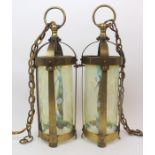 A PAIR OF ARTS AND CRAFTS BRASS CEILING LANTERNS of cylindrical form with vaseline glass shades with