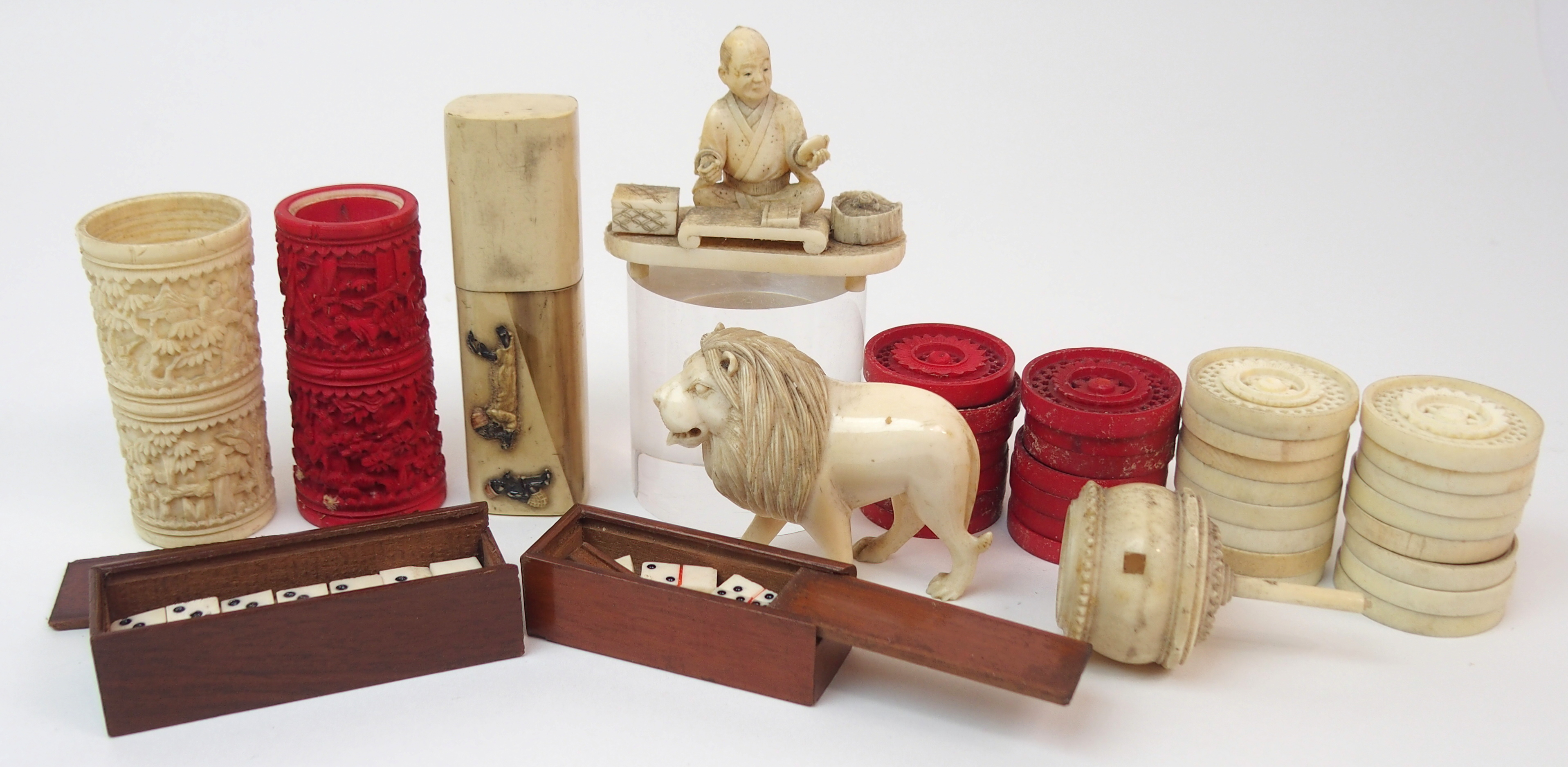 A SET OF THIRTY CARVED DRAUGHTS 3cm diameter, two Chinese dice tumblers, 6.5cm high, lion 5m high,