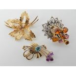 THREE VINTAGE BROOCHES a 9ct gold floral spray brooch, 4.2cm x 3.5cm, a 9ct brooch set with blue