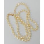 A STRING OF CREAM BAROQUE PEARLS WITH 9CT CLASP pearls approx 5.8mm each length of strand 57cm,