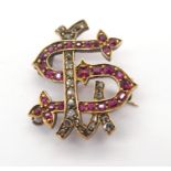 A BRIGHT YELLOW METAL DIAMOND AND RUBY MONOGRAM BROOCH the 'S & L' picked out in rubies and rose cut