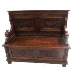 A VICTORIAN OAK BENCH carved with medieval style panels of figures merry making in Inns above a
