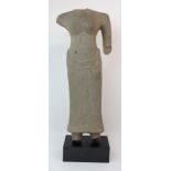 AN ASIAN STONE CARVING OF A FEMALE TORSO bare chested and wearing a ribbon tied patterned dress, (