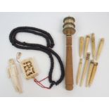 A GARLAND OF MALA BEADS with carved ivory pierced box, a Tibetan prayer wheel, 21cm long, a marine