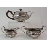 A VICTORIAN THREE PIECE SILVER TEA SERVICE by Edward Barnard & Sons Limited, London 1898, of squat