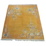 A CHINESE CARPET early 20th Century, the yellow field sparsely decorated with blossoming branches