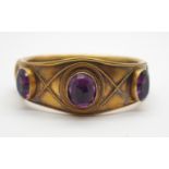 A BRIGHT YELLOW METAL AMETHYST SET VINTAGE BANGLE the amethysts are in foiled closed back