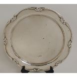 A SILVER SALVER by William Hutton Sons Limited, Sheffield 1907, of circular form with hammered