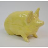 A WEMYSS WARE PIG glazed in yellow, impressed Wemyss Ware RH & S to base, 16cm long Condition