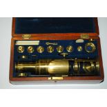 A VICTORIAN MAHOGANY CASED LACQUERED BRASS MICROSCOPE by J. P. Cutts, engraved J.P. Cutts, Opticians