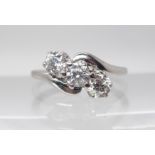 AN 18CT WHITE GOLD THREE STONE DIAMOND RING the three diamonds are estimated approx at just over 0.
