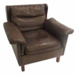 A DE SEDE OF SWITZERLAND BROWN BUFFALO LEATHER ARMCHAIR circa 1970, on square wooden legs, 76cm high